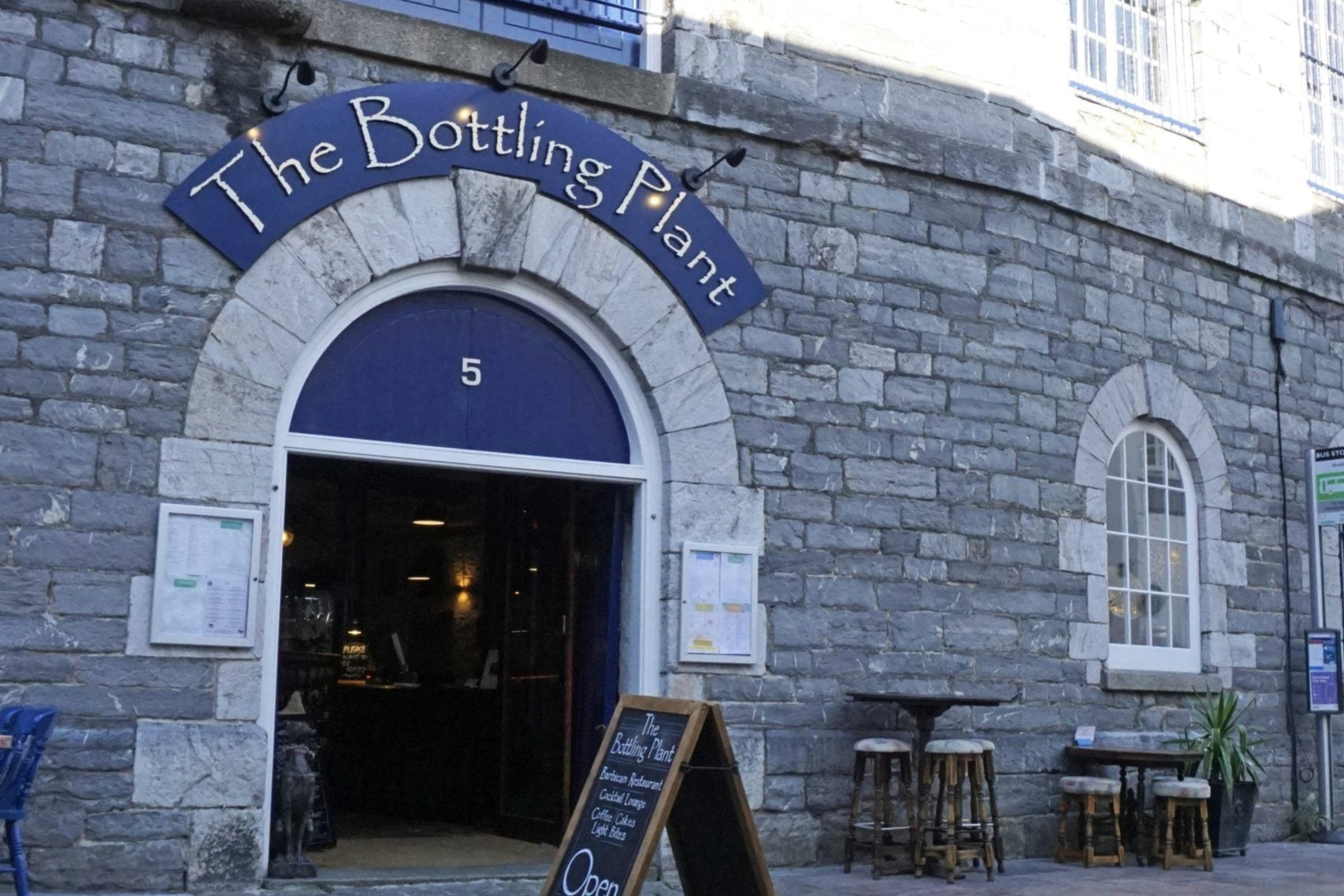 Stone building with 'The Bottling Plant' sign on a street corner.